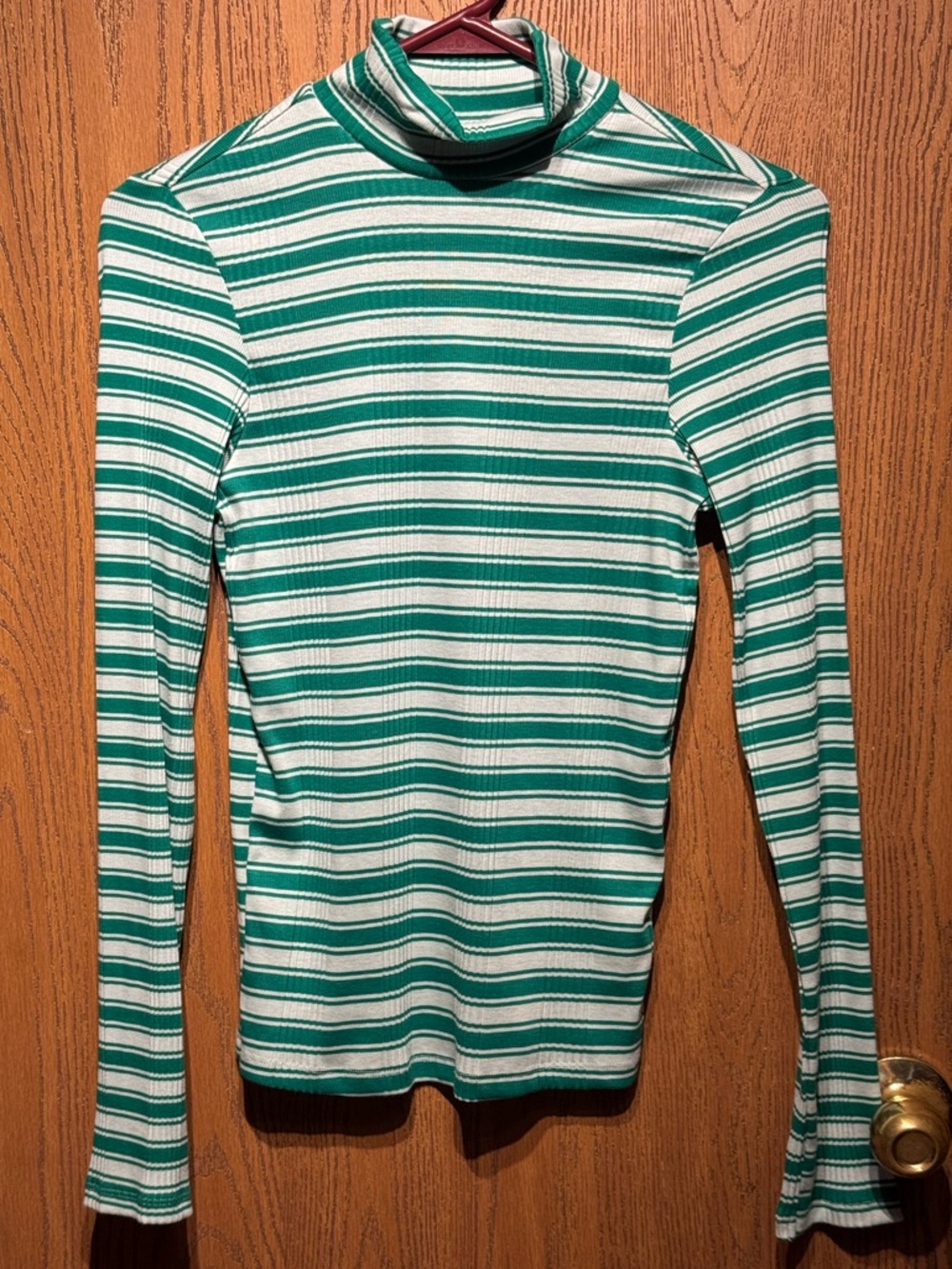 Victoria's Secret turtleneck is a green and white striped mock-neck top